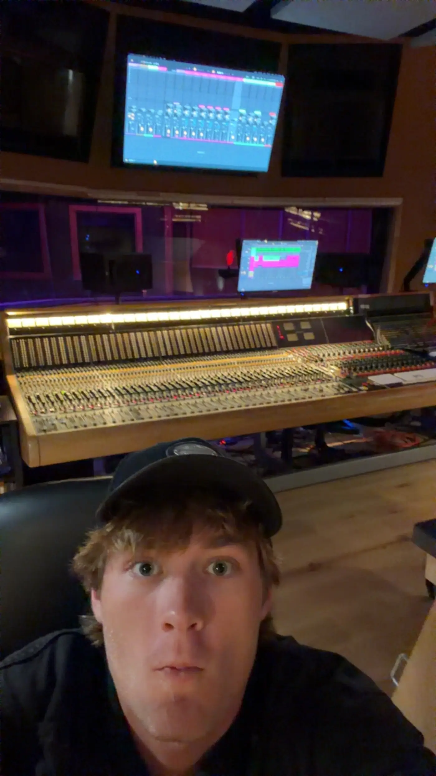 Cameron taking a selfie in a recording studio