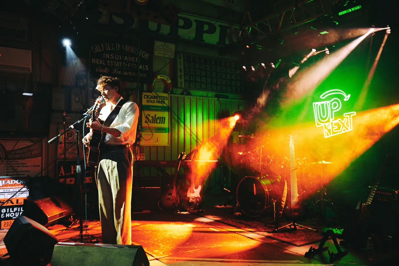 Wide shot of Cameron on a colorful stage